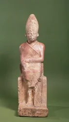 Seated statue of Pharaoh Khasekhem with conquered foes incised around the base, found at Hierakonpolis, c. 2700 BC